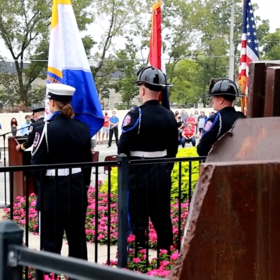 First Responders stand at attention during a ceremony at the memorial