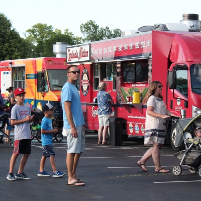 Guests line up for food; Cardinals Nation food truck in background