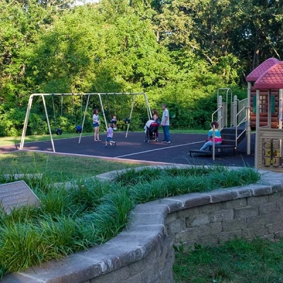 Fort Zumwalt Park's playground is surrounded by mature shade trees