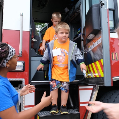 All aboard! Kids love exploring the Fire Department's big red fire truck.